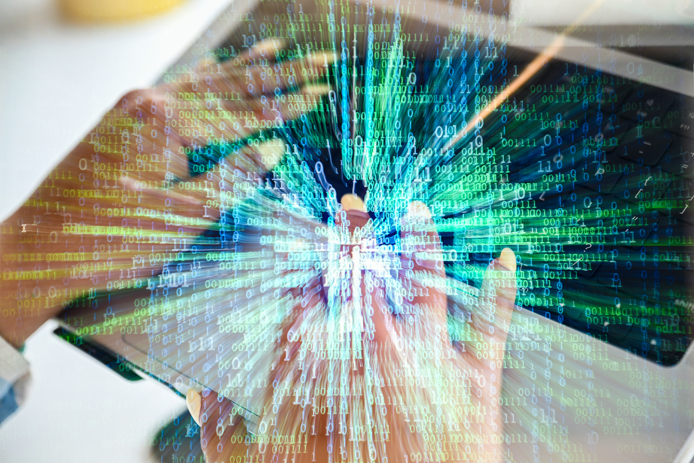 Hands typing on a laptop with a digital overlay of binary code and data streams, illustrating cybersecurity.