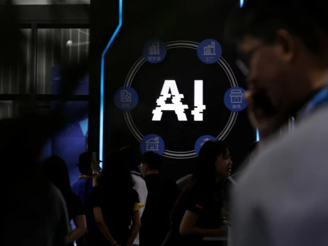 visitors stand near a sign of artificial intelligence at an ai robot booth at security china an exhibition on public safety and security in beijing china june 7 2023 reuters