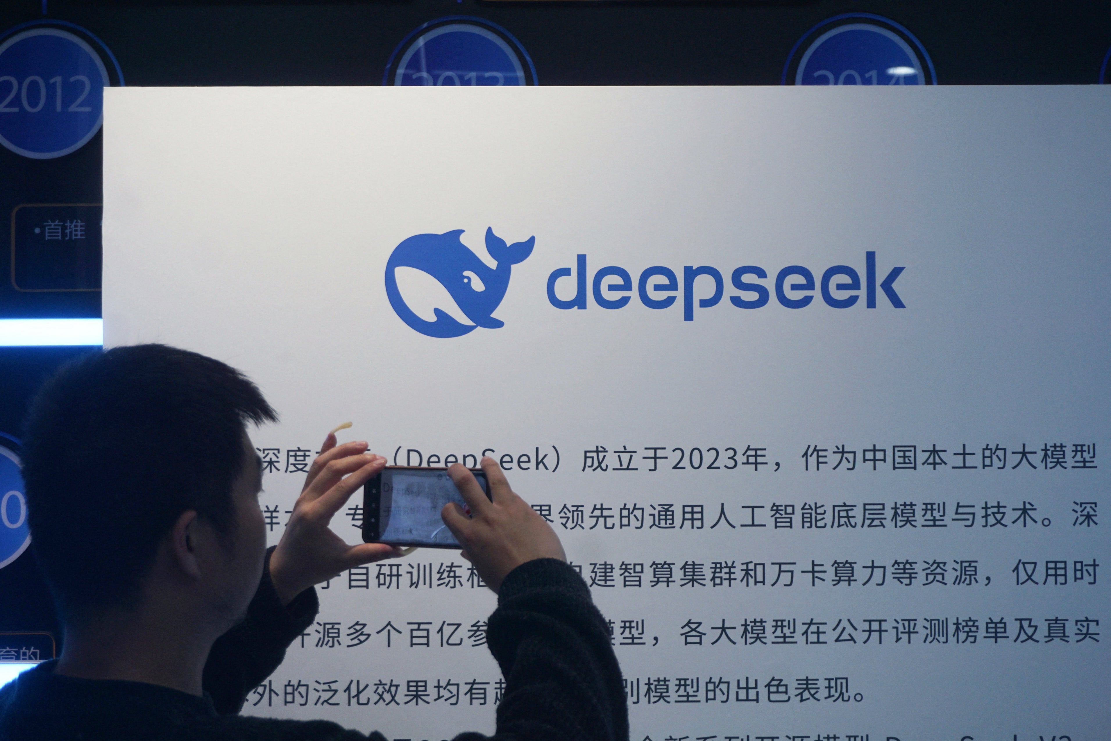 A man takes photos of a DeepSeek display at a shopping mall in Hangzhou, in China's eastern Zhejiang province on April 23, 2026. Chinese startup DeepSeek released a new artificial intelligence model with 