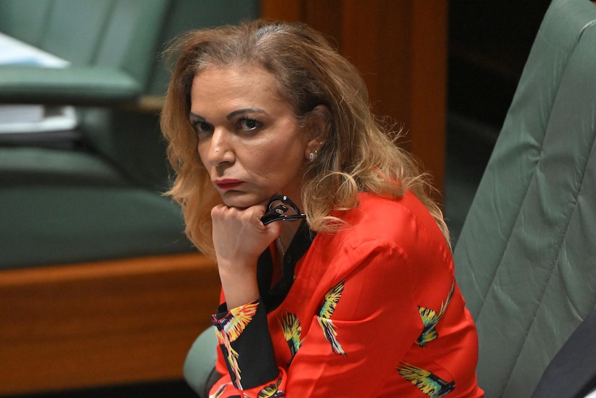 A woman sits on the floor of parliament