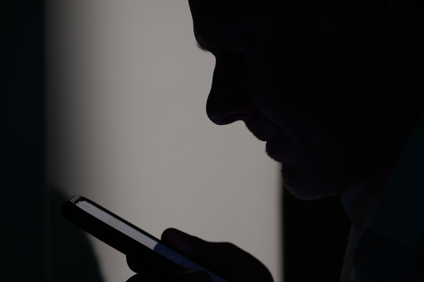 A person looking at their phone intently.