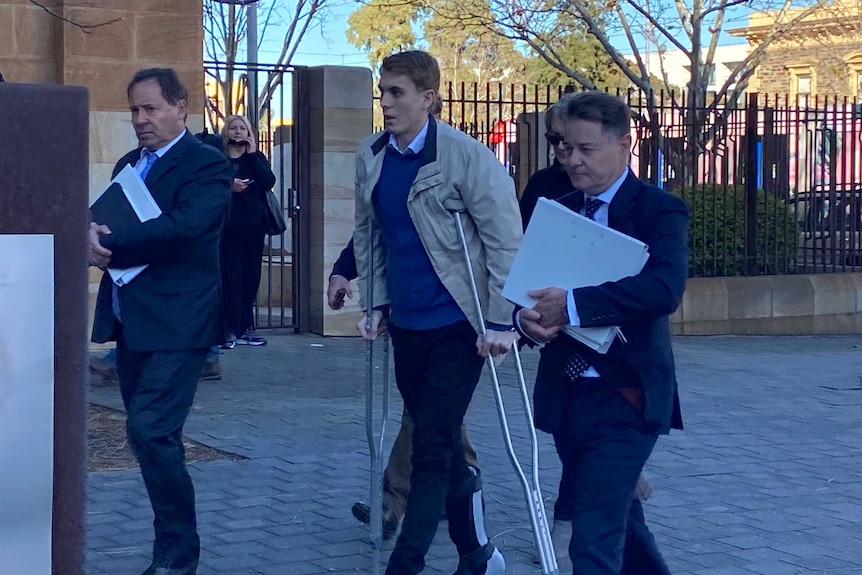 Charged driver Harrison Kitt and others outside an Adelaide court.