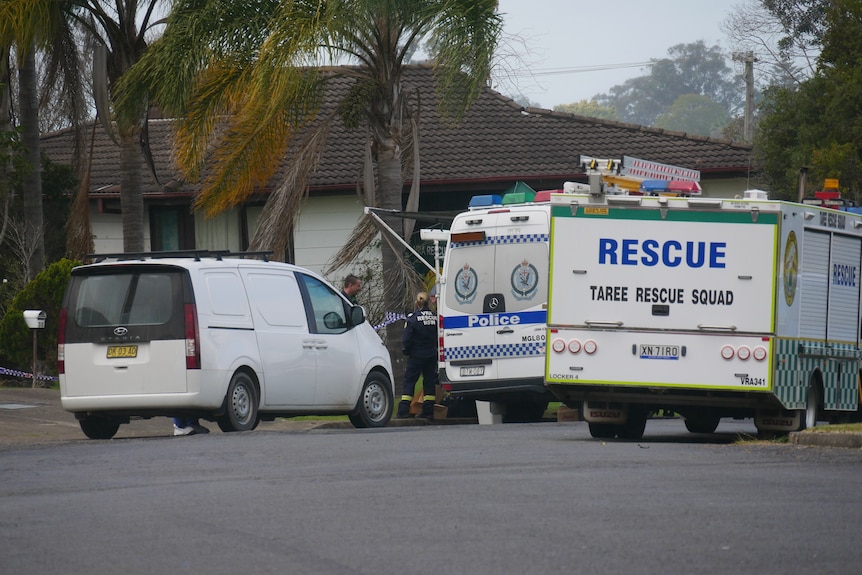 Police vehicles on a street in Taree.