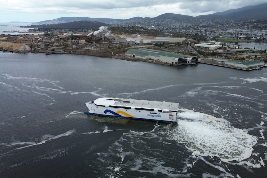 A ferry on the River Derwent with Hobart in the background, photographed from above.