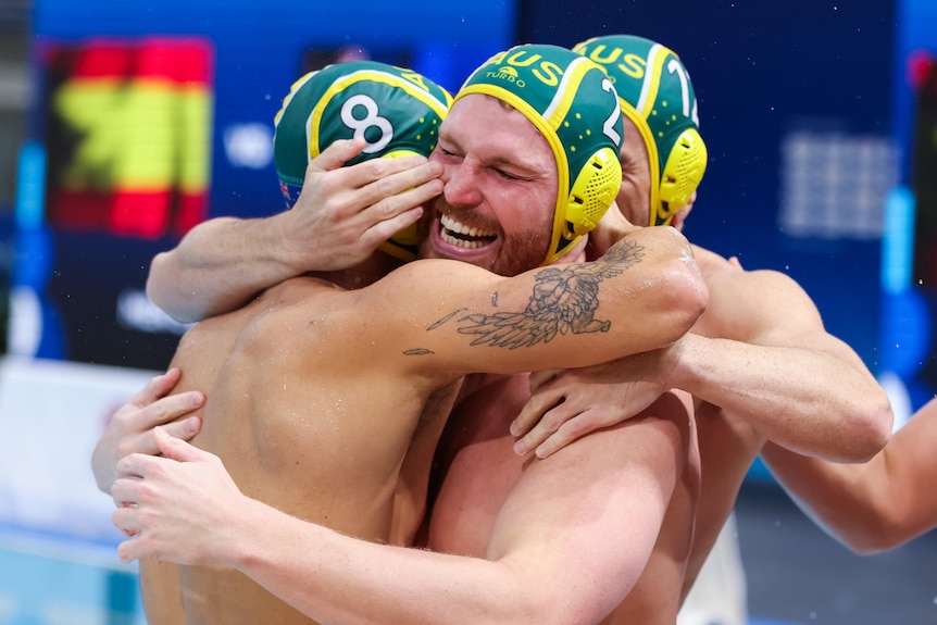 Australian water polo players hug