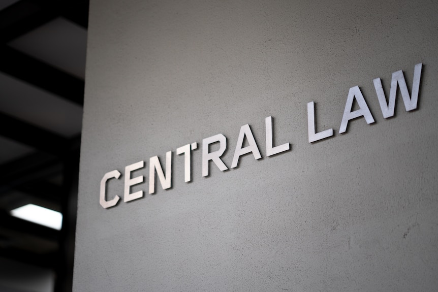 Exterior of a court building featuring silver steel lettering.