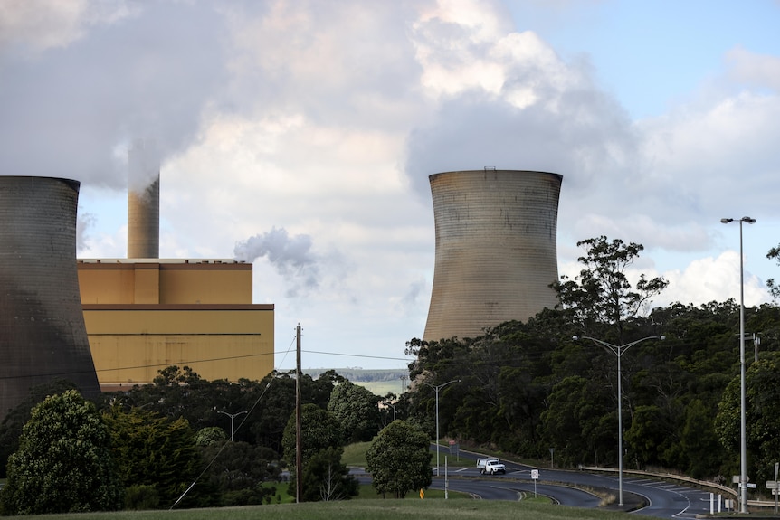 A power station emits a cloud of white vapour.