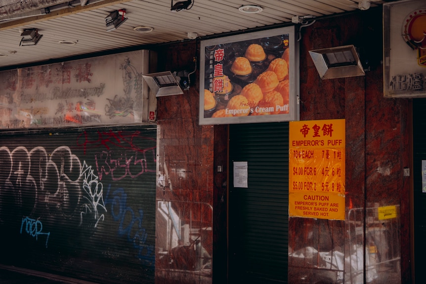 Closure signs in a Chinatown environment of a stalled up shopfront.