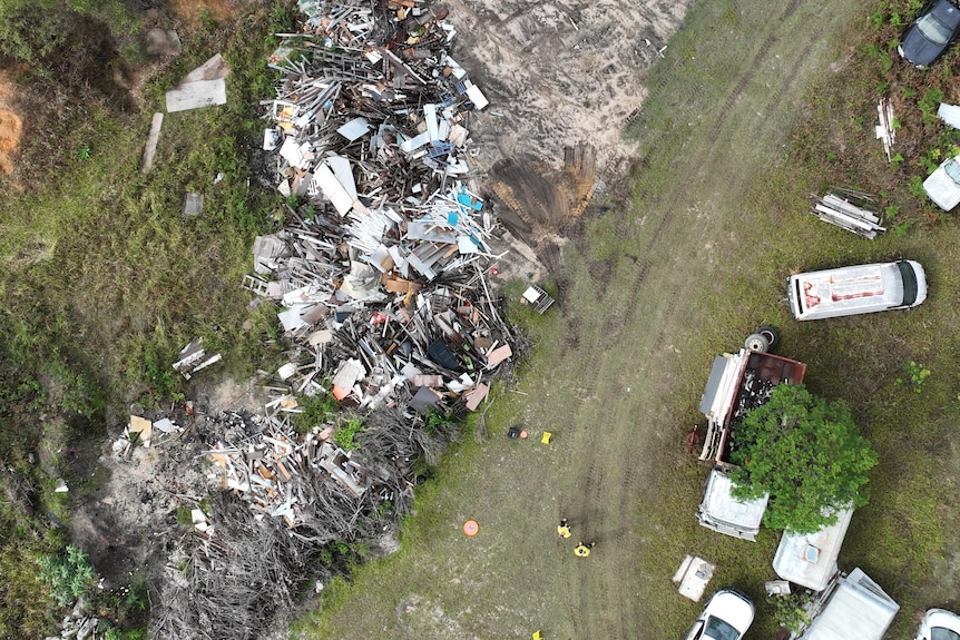 Piles of rubbish dumped on grass.
