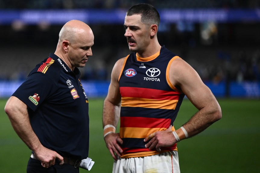 Adelaide Crows head coach Matthew Nicks and Taylor Walker of the Crows speaking on the football field