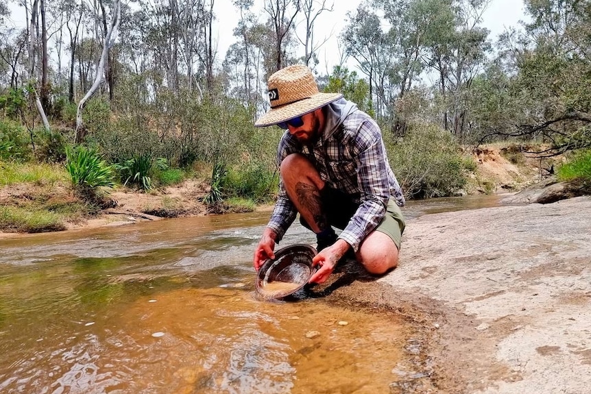 Chris panning for gold in a river