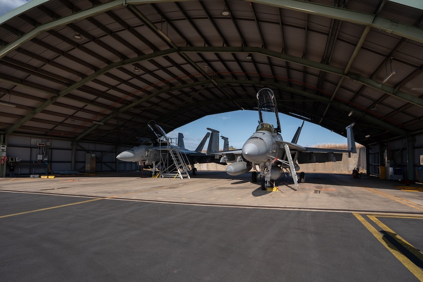 Two jets in a hanger.