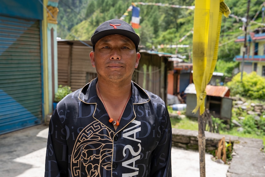 A close up of a Nepalese man wearing a cap.