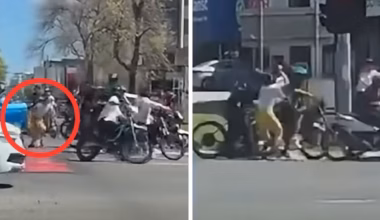 Woman punches e-bike rider after gang kicks her car