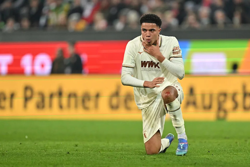 Noahkai Banks of FC Augsburg kneels on the pitch during the Bundesliga match between FC Augsburg and 1. FC Koln at WWK-Arena on Feb. 27, 2026 in Augsburg, Germany.