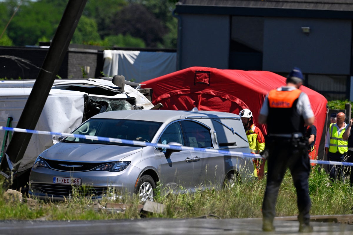 Four dead including two children after train collides with school bus at level crossing in Belgium