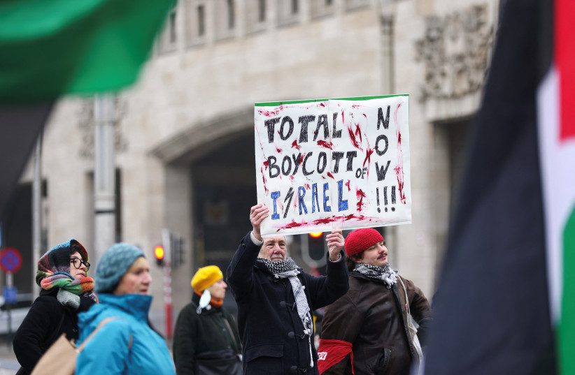 A man holds a placard as he attends a demonstration in support of Palestinians in Gaza, amid a ceasefire between Israel and Hamas, in Brussels, Belgium January 19, 2025.