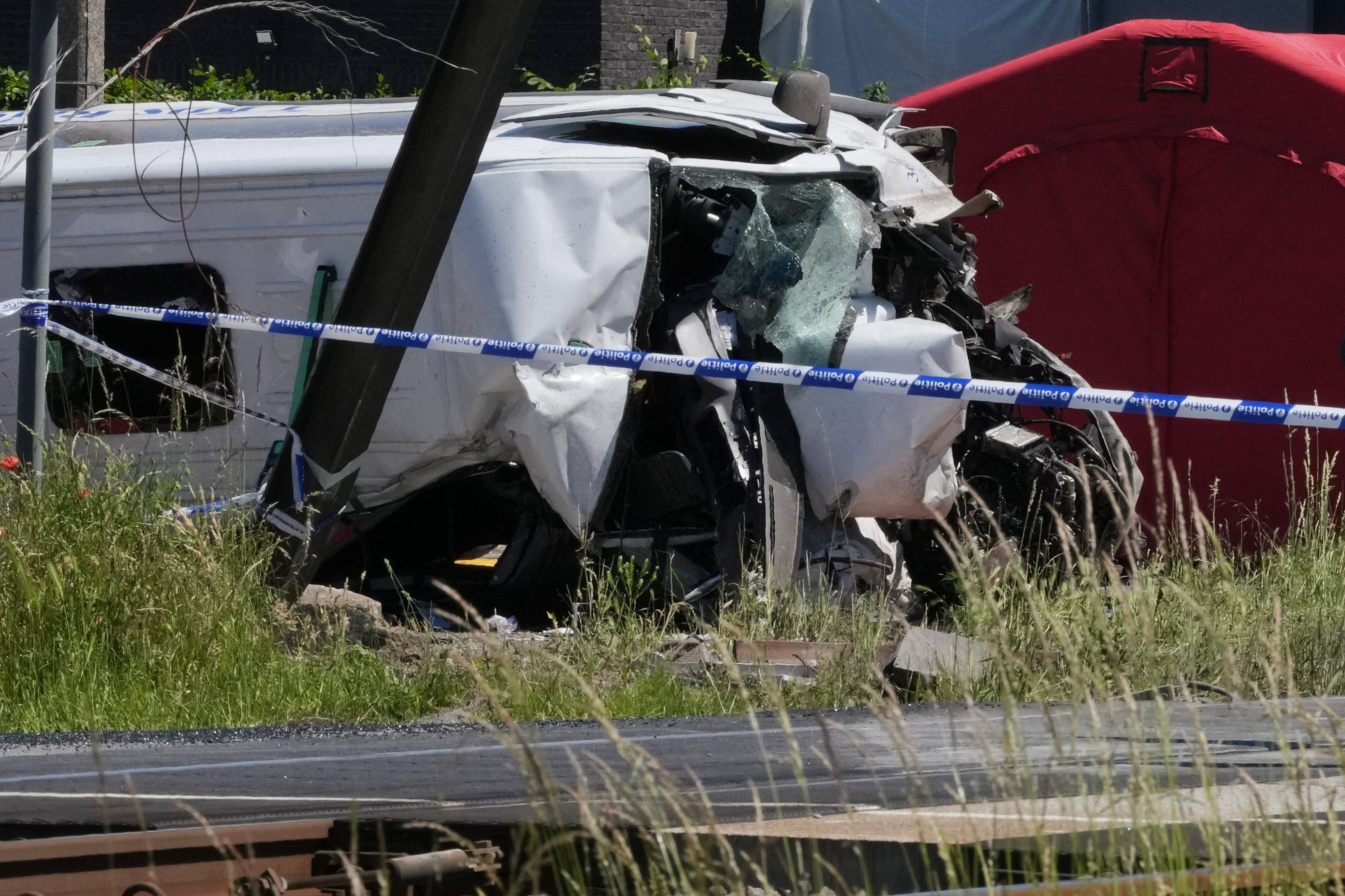 Police tape cordons off a level crossing where a train collided with a van