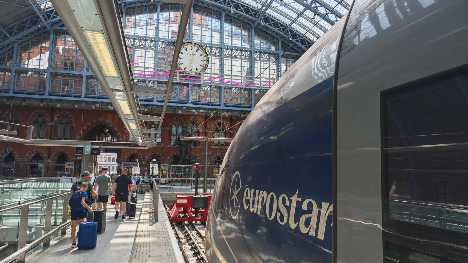 Eurostar train beside passengers at London St Pancras International