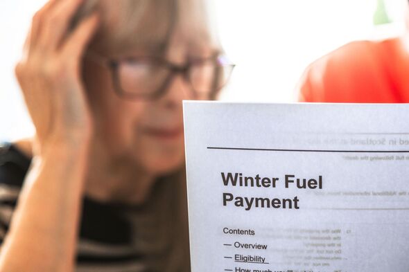 Senior woman looking at winter fuel payment documents during cost of living crisis Senior woman looking at winter fuel payment documents during cost of living crisis