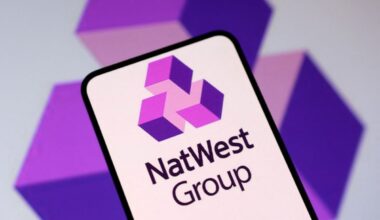 NatWest bank logo prominently displayed on a modern glass building, reflecting the financial institutions corporate identity.