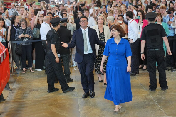 Andy Burnham with colleagues from the Parliamentary Labour Party in Westminster Hall at the Houses of Parliament in central London, as he returns to the House of Commons to take up his seat after winning the Makerfield by-election, Monday June 22, 2026. (Yui Mok/PA via AP)