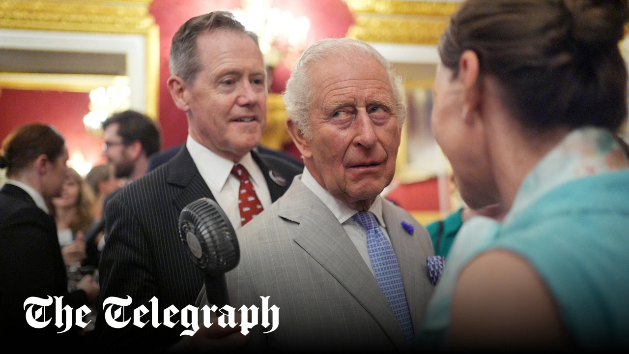 King fanned by aide as London wilts in heatwave