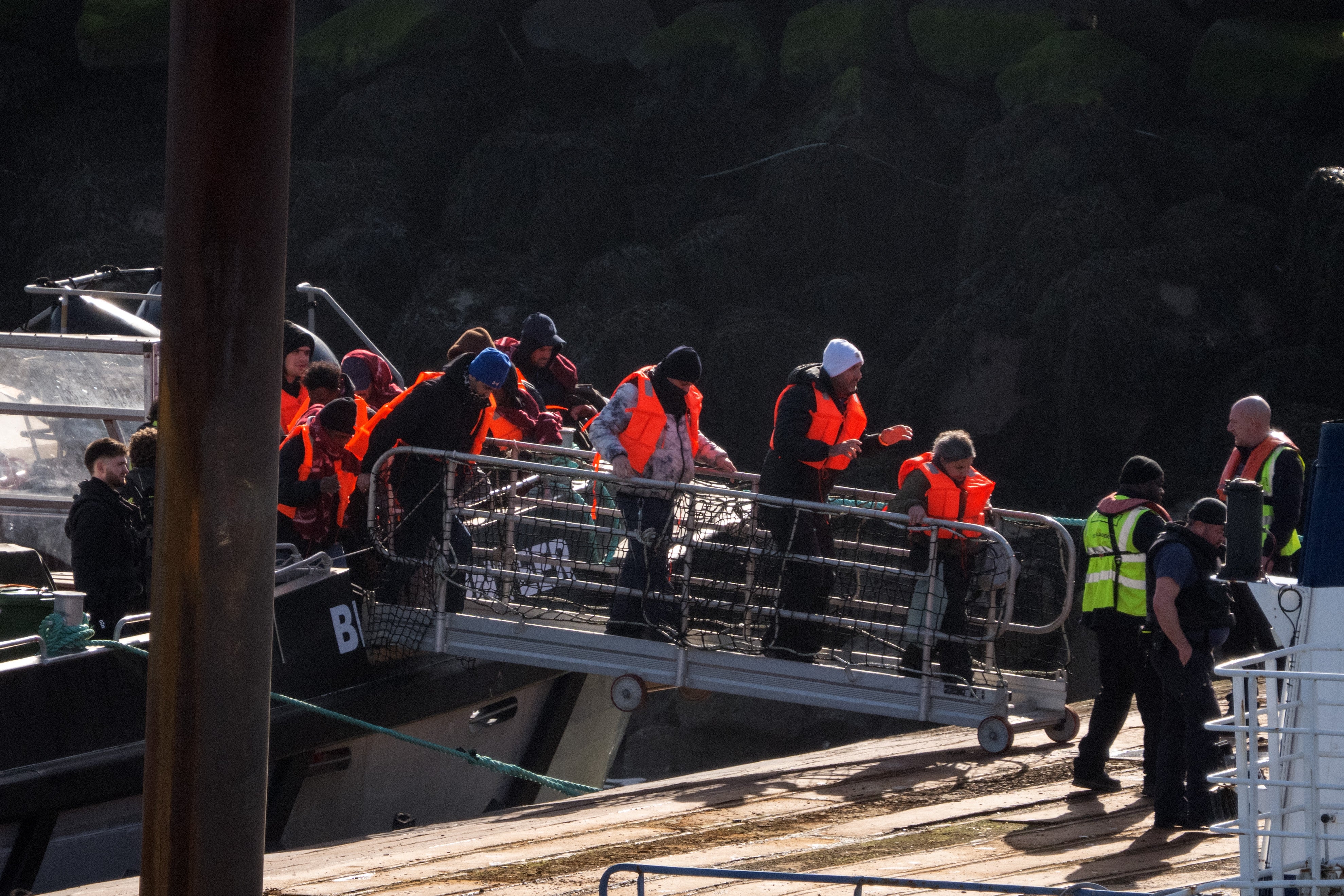 Migrants disembark from a Border Force vessel into Ramsgate port. AI age-checking technology works worse on faces aged by the stress of irregular journeys.