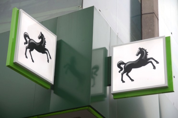 Lloyds headquarters exterior against a clear sky, showcasing iconic modern architecture in a bustling business district