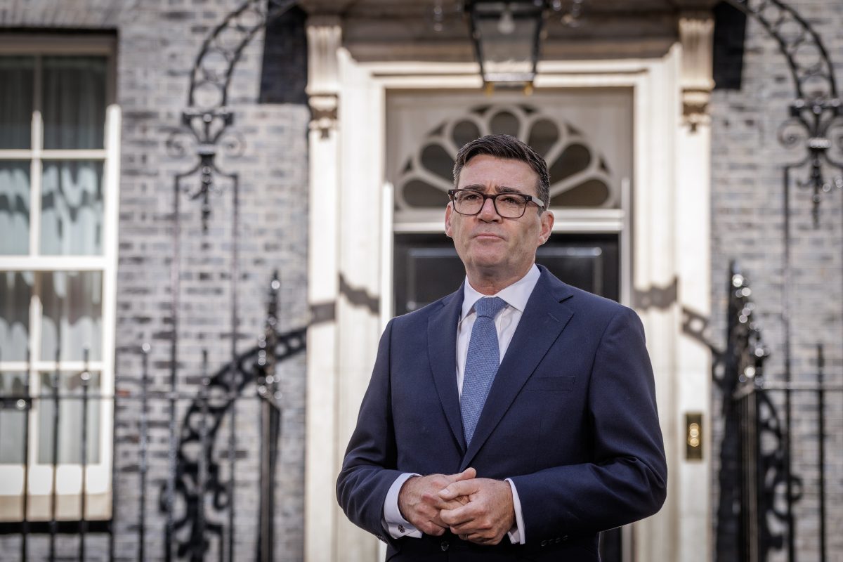 Andy Burnham, Mayor of Greater Manchester, standing outside 10 Downing Street in a suit and tie.