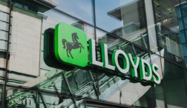 Lloyds Bank logo and sign on the exterior glass facade of a modern building in Manchester