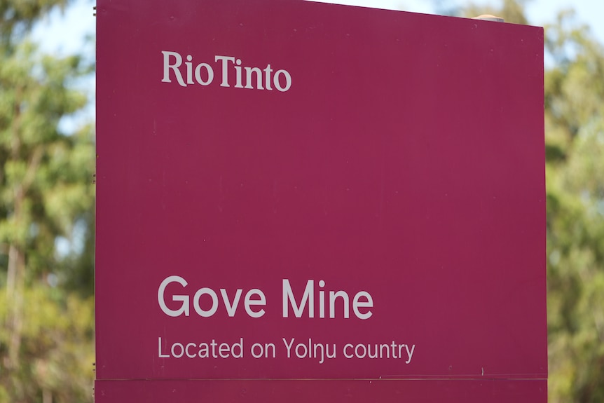 A maroon sign with white text reads: Rio Tinto, Gove Mine, located on Yolngu country.