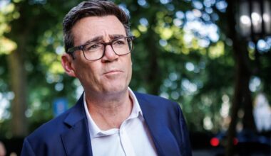 Andy Burnham speaking at a press conference, expressing confidence despite challenges, highlighting leadership and resilie...
