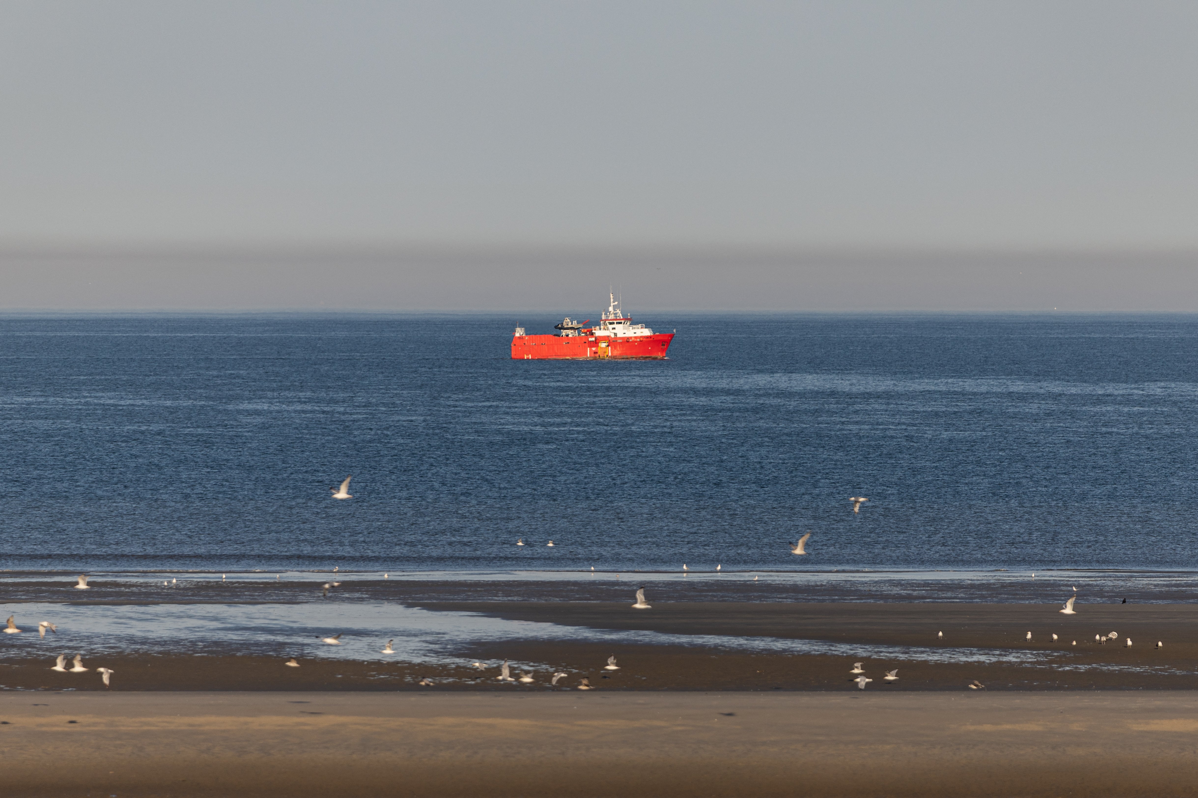 This photograph shows the rescue vessel 'The Minck' sailing off the beach of Hardelot, from where migrants often attempt to cross the English Channel, in Neufchatel-Hardelot, northern France