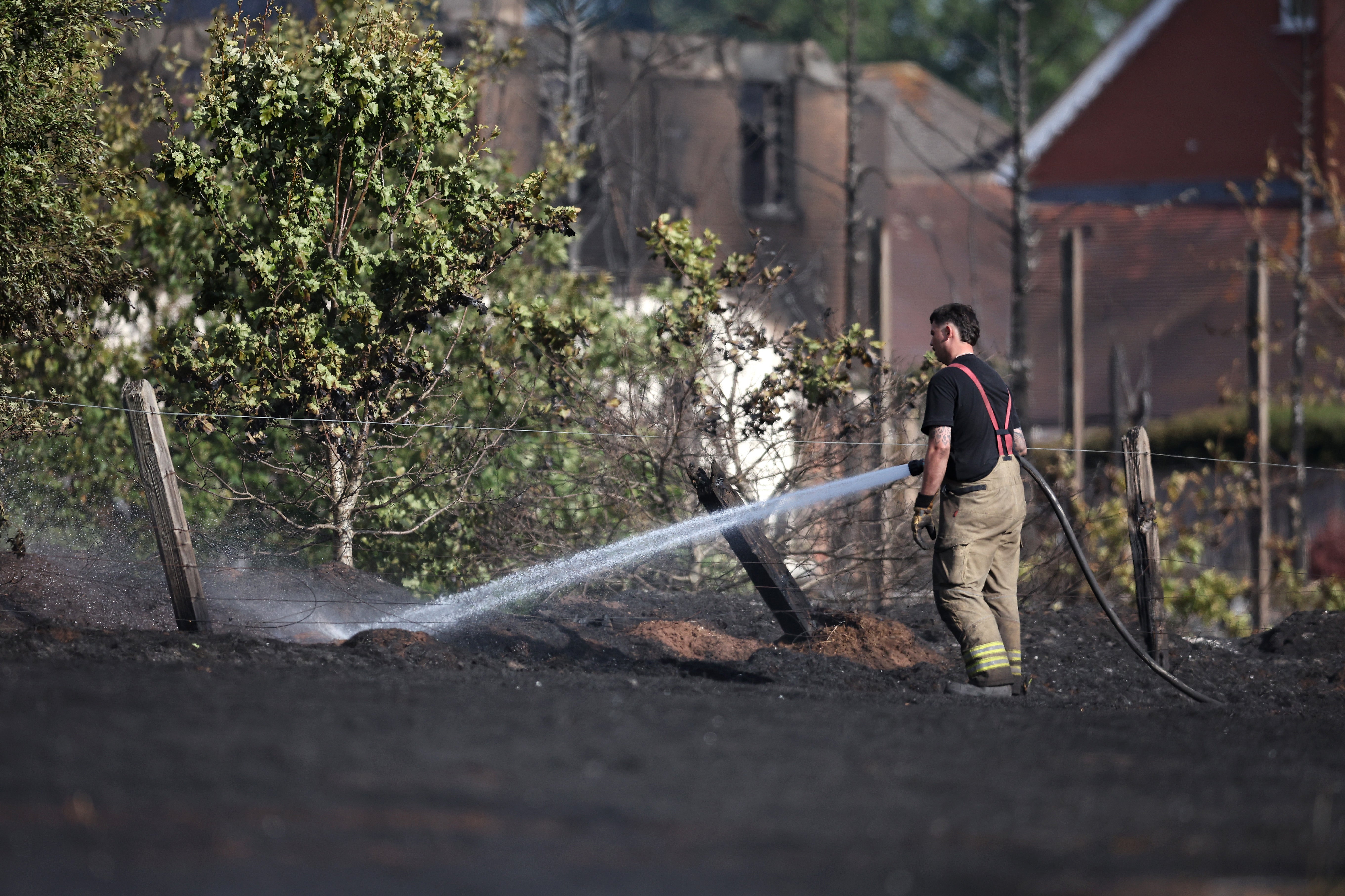 There have been several wildfires this summer, including in the West Midlands. Here, emergency services attend the scene near the burnt out remains of homes following a huge fire in Stourbridge