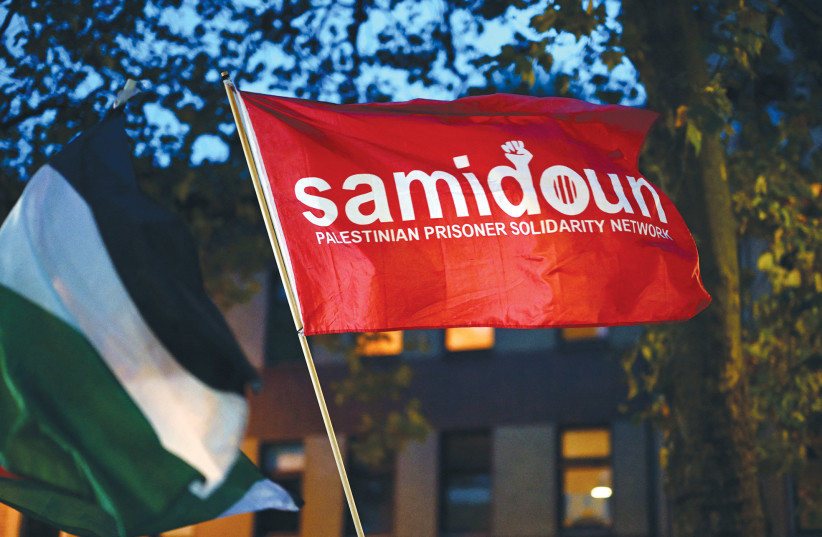 A Samidoun flag is flown at a Duisburg demonstration in Germany, October 9, 2023.