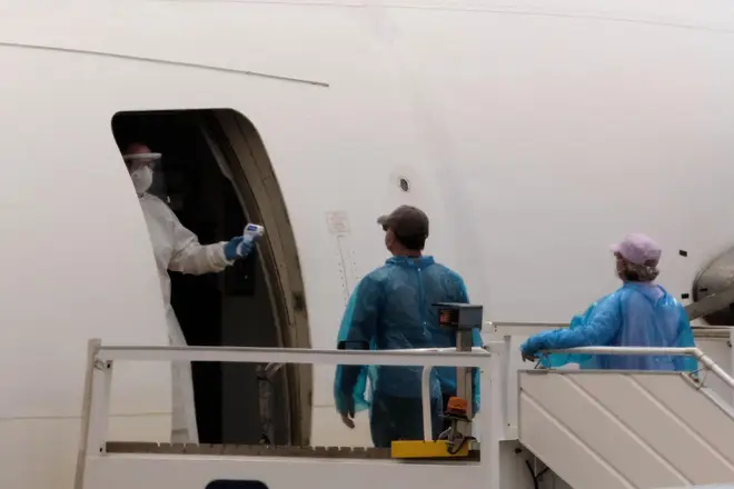 Passengers are screened with a temperature scanner before boarding a plane bound for Canada, after disembarking from the hantavirus-stricken cruise ship MV Hondius at the airport in Tenerife, Canary Islands, Spain, Sunday, May 10, 2026
