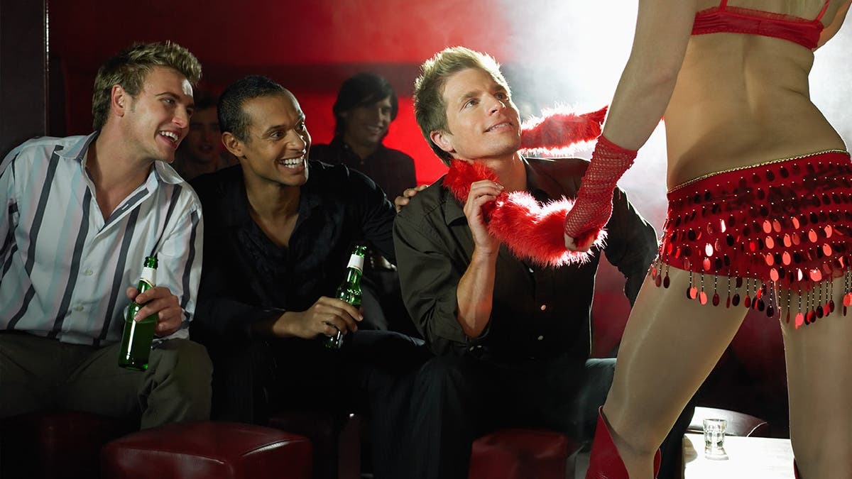 Stripper and some guys watching her