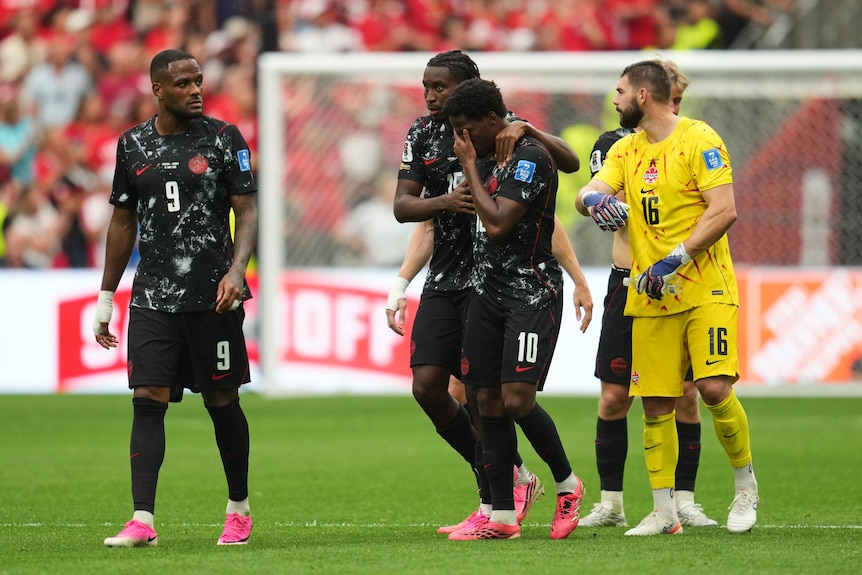 Jonathan David is upset alongside Canadian teammates after seeing Ismael Kone break his leg