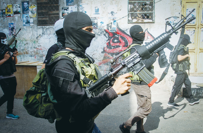 PALESTINIAN GUNMEN from al-Aqsa Martyrs Brigades hold a military parade in the Balata refugee camp, east of Nablus, last week. Israel need not apologize for defending itself against Palestinian terrorist cells, says the writer.