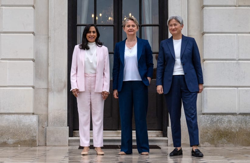 Britain's Foreign Secretary, Yvette Cooper (C), poses for a photograph with Australian Minister for Foreign Affairs, Penny Wong (R), and Canadian Foreign Minister, Anita Anand, in the garden of Chevening House on June 11, 2026 in Sevenoaks, England.