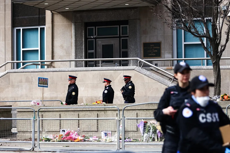 Cole Burston/AFP via Getty Images - PHOTO: Toronto Police officers work around the scene of a shooting at the US Consulate in Toronto, Canada, March 10, 2026.