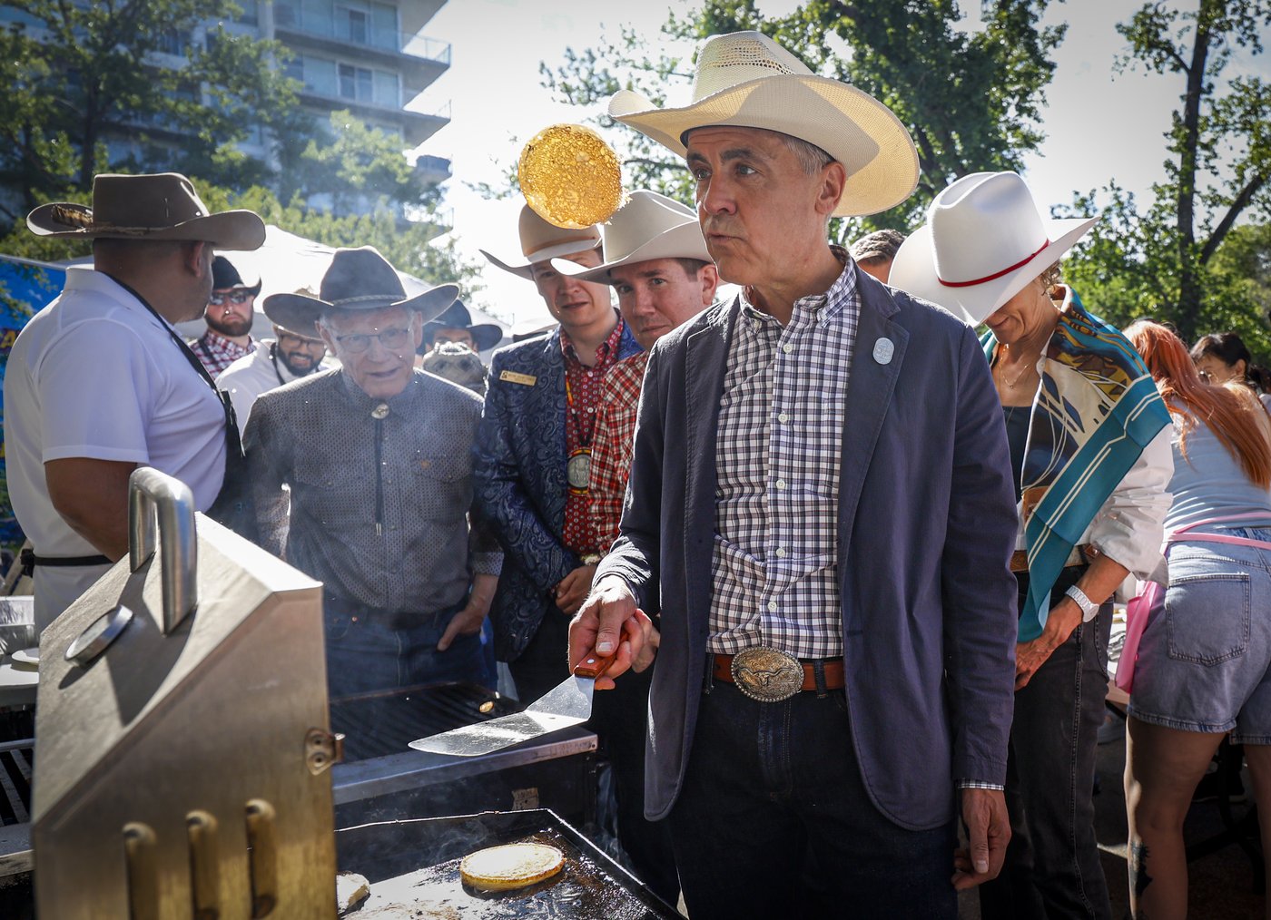 Carney perfects flipping Stampede flapjacks as separatists host similar breakfast