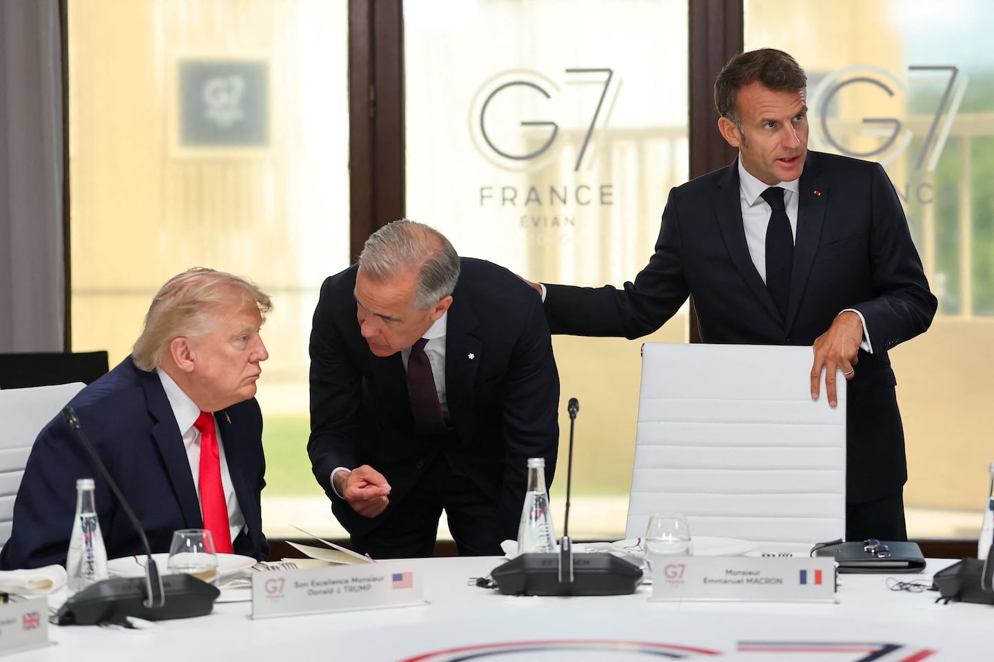 President Trump (left) and Canadian Prime Minister Mark Carney (center) at a working lunch with leaders of G7 and the Middle East in Evian-les-Bains, France, on June 16, with French President Emmanuel Macron (right).