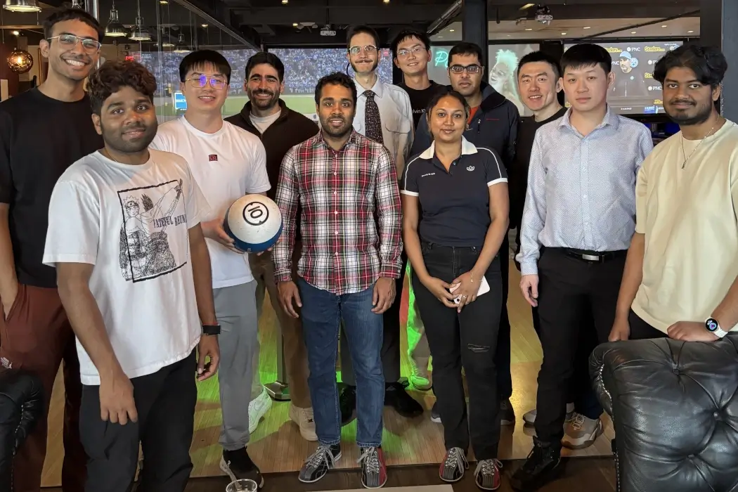 The Skyfall AI team pose together at a bowling alley.