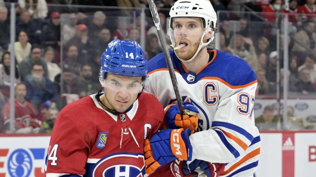 Montreal Canadiens forward Nick Suzuki (14) and Edmonton Oilers forward Connor McDavid (97) during the third period at the Bell Centre.