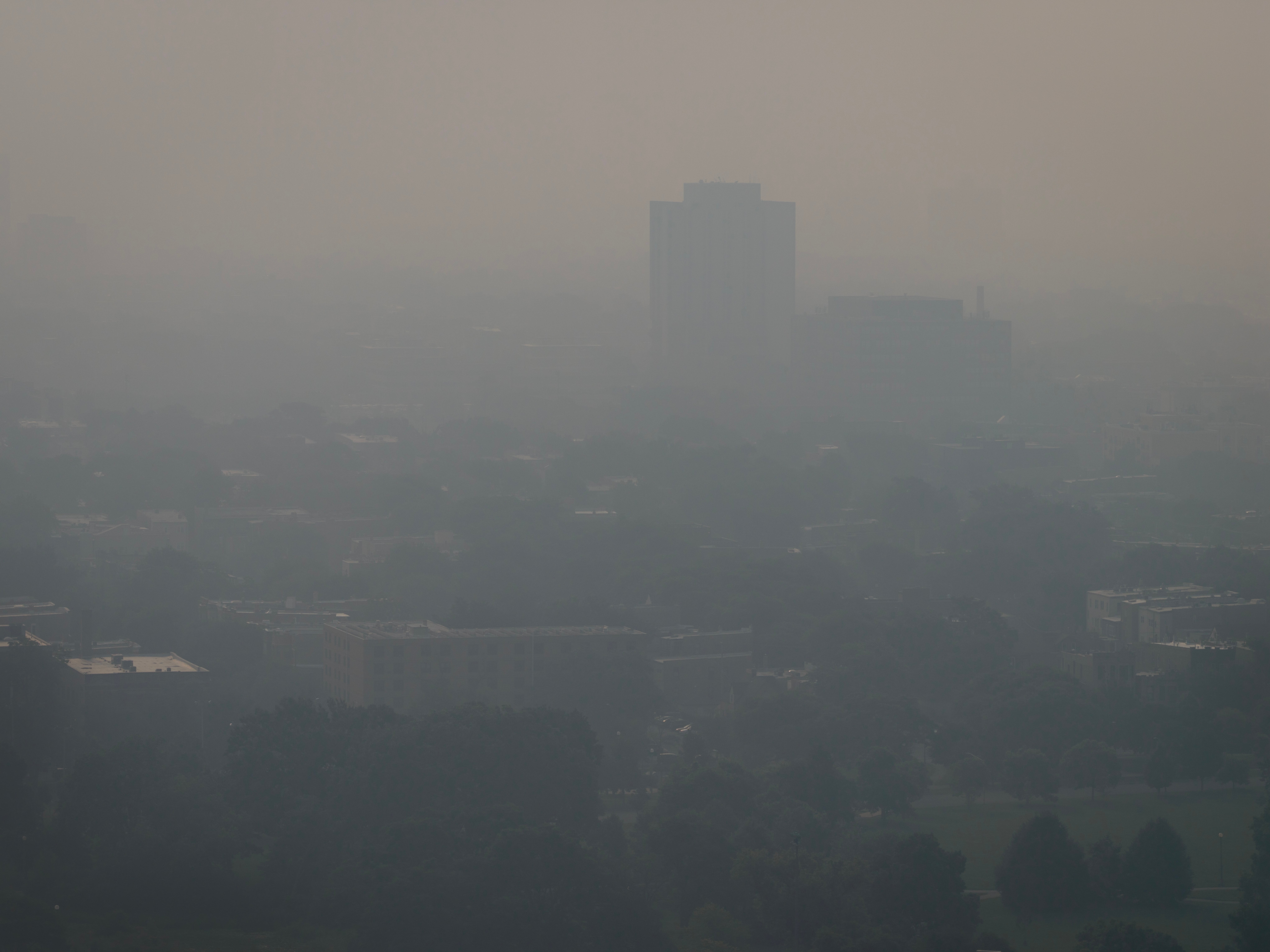 An aerial view shows smoke from Canadian wildfires over Chicago, Illinois, on Thursday. Wildfire smoke can bring decreased visibility that impacts transportation