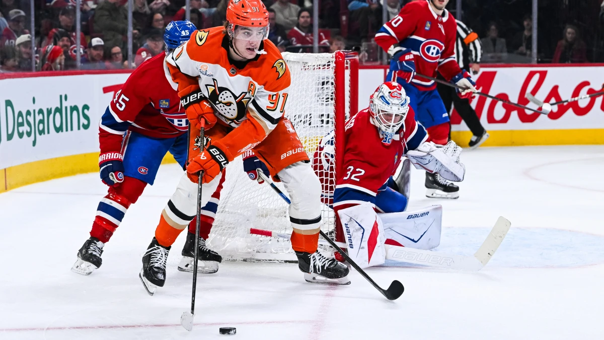 Anaheim Ducks center Leo Carlsson (91) plays the puck against Montreal Canadiens defenseman Alexandre Carrier (45) near goalie Jacob Fowler (32) net during the second period at Bell Centre.
