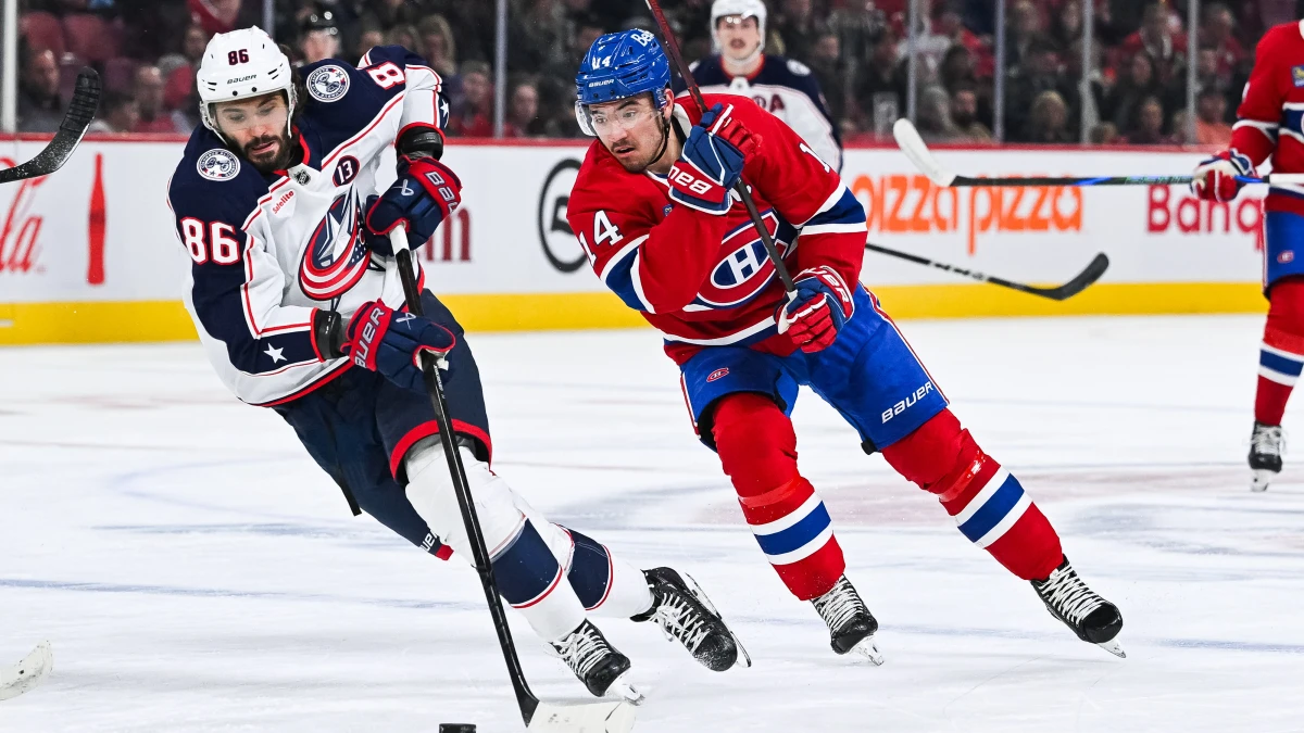 Columbus Blue Jackets right wing Kirill Marchenko (86) plays the puck against Montreal Canadiens center Nick Suzuki (14) during the first period at Bell Centre.