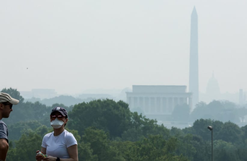 Visitors to the Netherlands Carillon experience the smoke from Canadian wildfires as it clouds the Washington skyline as seen from Arlington, Virginia, US, July 17, 2026.